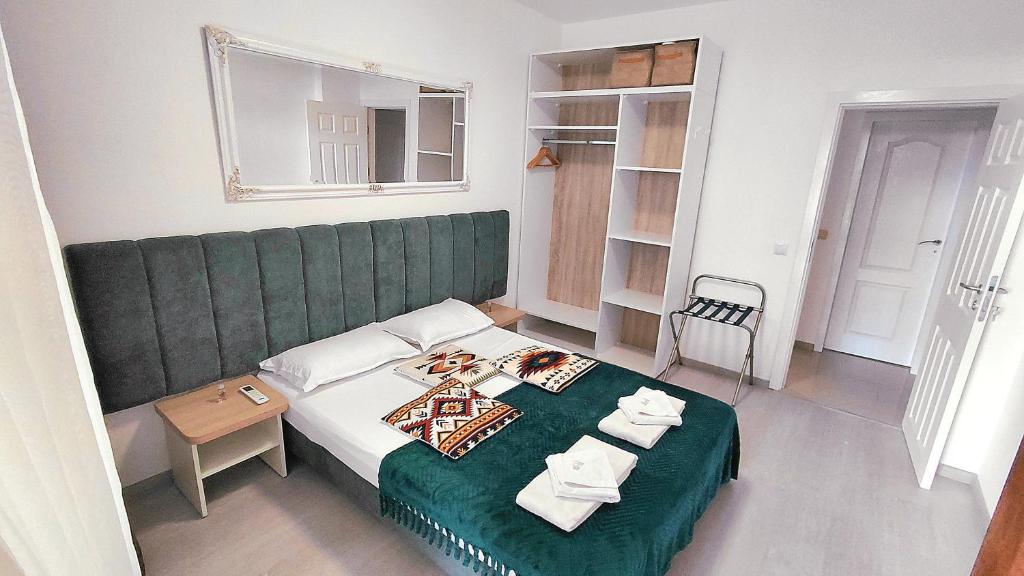 First room with double bed and a wardrobe.