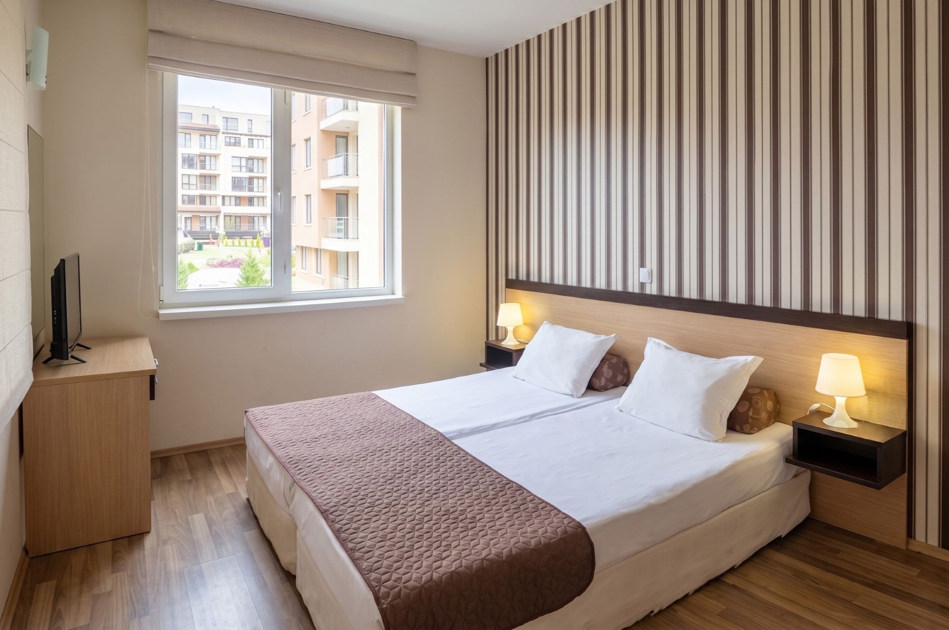 Bedroom with double bed and TV.