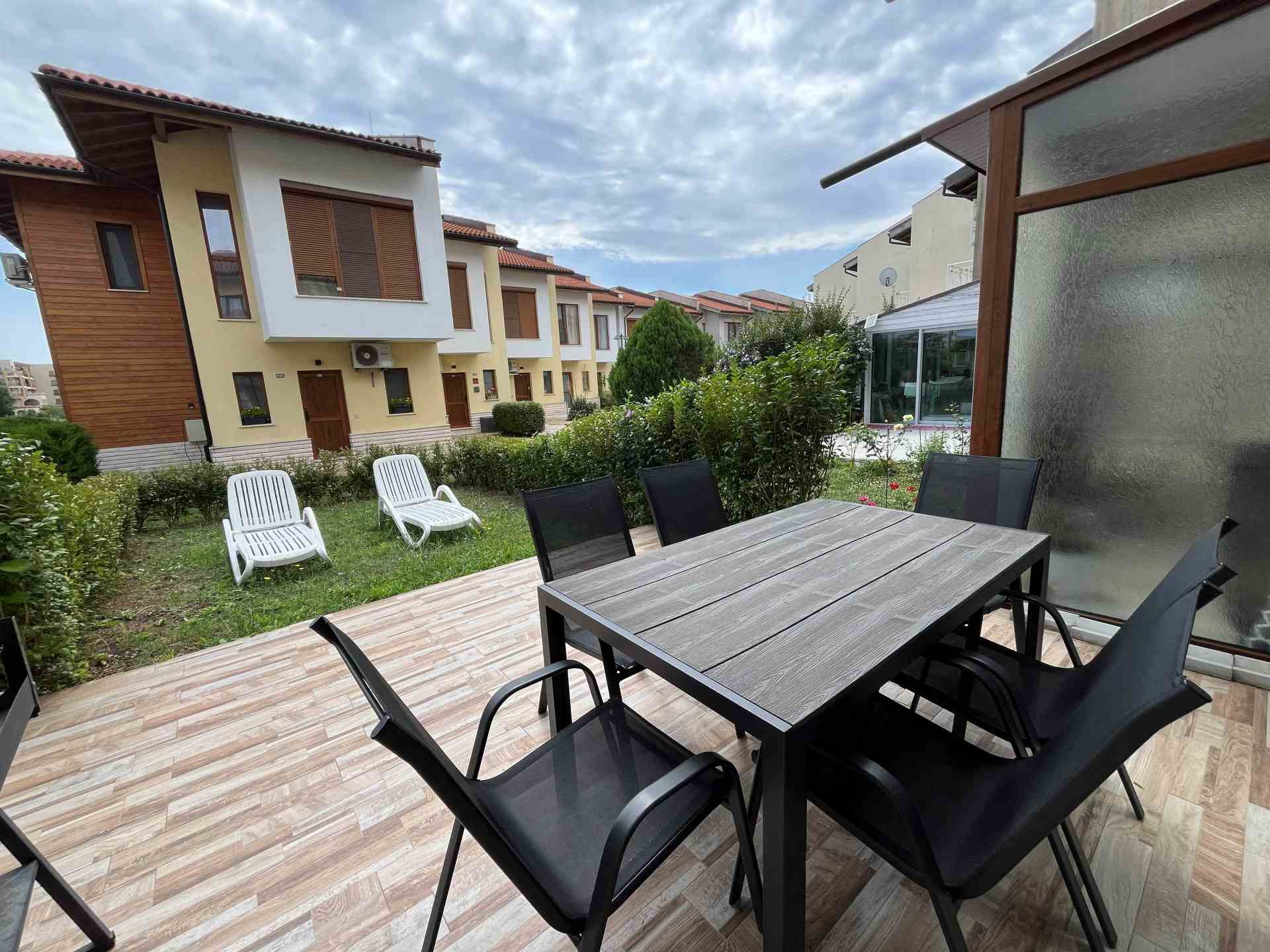 Patio with dining table and tanning beds.